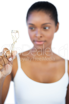 Woman looking at her eyelash curler