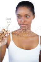 Woman looking at her eyelash curler