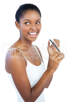 Smiling woman using nail file