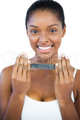 Smiling woman holding nail file
