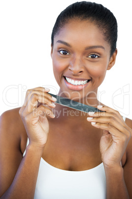 Cheerful woman holding nail file