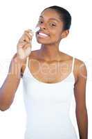 Smiling woman smelling her lip balm