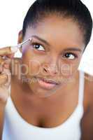 Concentrated woman using tweezers