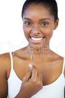 Smiling woman holding her tweezers