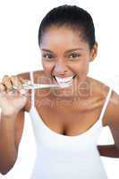 Smiling woman brushing her teeth