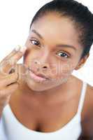 Woman putting moisturizer on her face