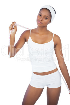 Slim woman holding measuring tape