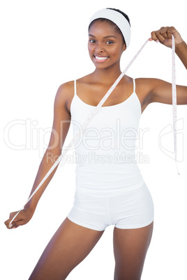 Fit woman holding measuring tape