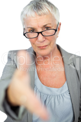 Serious woman with glasses presenting her hand for handshake