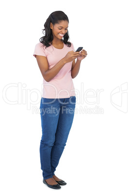 Young woman smiling and using mobile phone