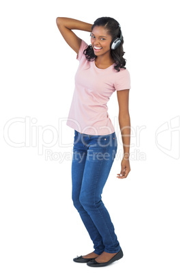 Smiling woman listening to music and dancing