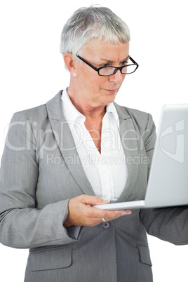 Businesswoman with glasses watching her laptop