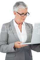 Businesswoman with glasses watching her laptop