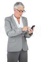 Businesswoman with glasses texting a message on her mobile phone
