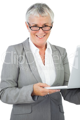 Smiling businesswoman with glasses holding her laptop