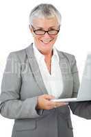 Smiling businesswoman with glasses holding her laptop