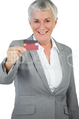 Happy businesswoman showing her credit card