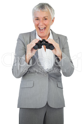 Smiling businesswoman holding binoculars