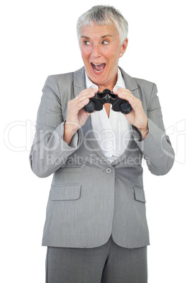 Happy businesswoman holding binoculars