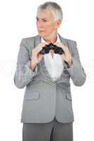 Unsmiling businesswoman holding binoculars