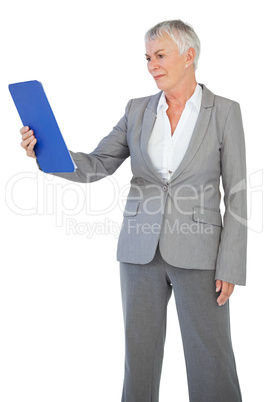 Businesswoman looking at clipboard