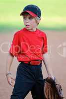 Little league baseball player looking sideways