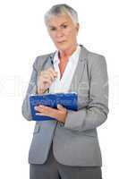 Serious businesswoman holding her clipboard