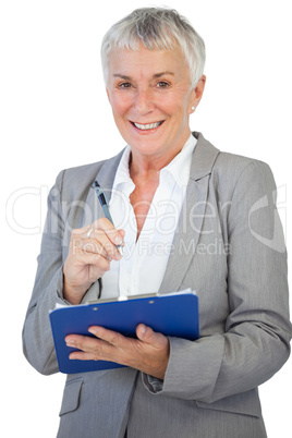 Happy businesswoman using her clipboard