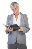 Concentrated businesswoman reading notepad