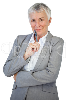 Cheerful businesswoman holding pen