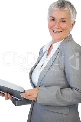 Smiling businesswoman holding notepad