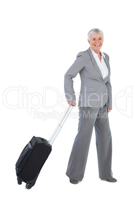 Smiling businesswoman with her luggage