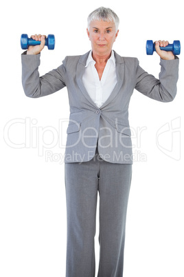 Businesswoman holding dumbbells