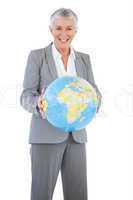 Smiling businesswoman holding globe