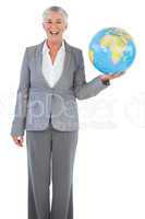 Happy businesswoman holding globe