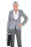 Happy businesswoman holding briefcase and putting her hand on hi