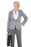Smiling businesswoman holding briefcase and putting her hand on
