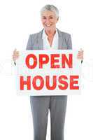 Estate agent holding sign for open house