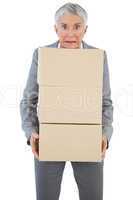 Businesswoman holding heavy cardboard boxes