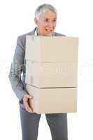 Happy businesswoman holding cardboard boxes