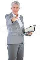 Businesswoman with diary pointing her finger at camera