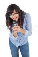 Cute woman wearing glasses and singing with her microphone