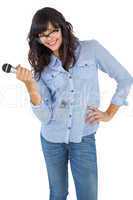Cute woman with her hand on hip holding microphone
