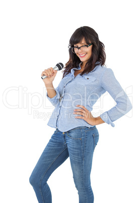 Smiling brunette with her hand on hip singing