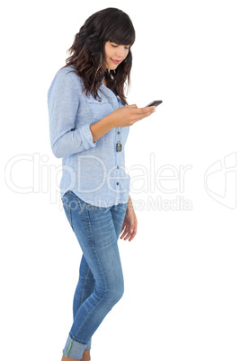 Brunette with her mobile phone texting a message