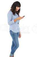 Brunette with her mobile phone texting a message