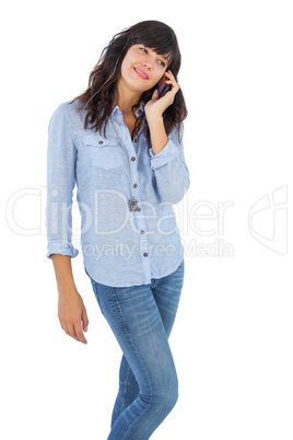Happy brunette with her mobile phone calling someone
