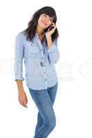 Happy brunette with her mobile phone calling someone
