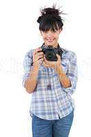 Young woman holding camera for taking picture