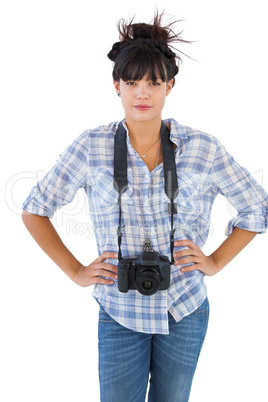 Young woman with camera put hands on her hips